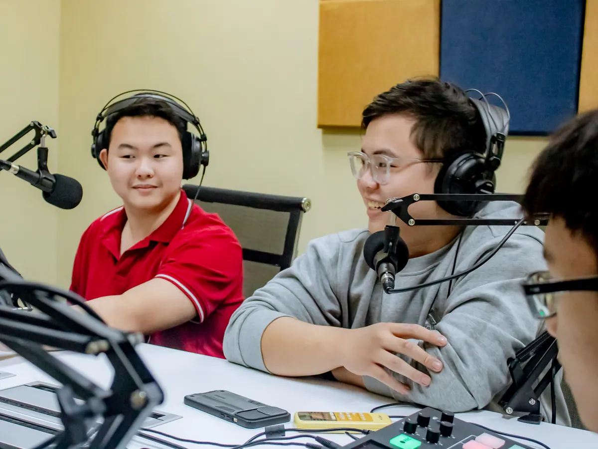 Two AUV students recording a show in the podcast studio